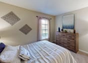 Thumbnail 12 of 27 - a bedroom with a bed and a window
