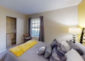 Thumbnail 8 of 27 - a bedroom with a large bed and a desk in a room