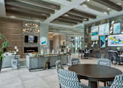 Thumbnail 20 of 36 - a dining room with a table and chairs and a fireplace at The Addison on Long Bayou Apartments, Seminole, Florida