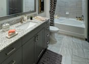 Thumbnail 7 of 36 - a bathroom with a sink and a shower and a toilet at The Addison on Long Bayou Apartments, Seminole