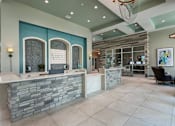 Thumbnail 24 of 36 - the lobby of a spa with a reception desk at The Addison on Long Bayou Apartments, Seminole, FL, 33772