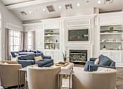 Thumbnail 7 of 20 - spacious resident clubhouse with tan chairs and blue couches