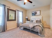 Thumbnail 8 of 26 - a bedroom with a bed and a ceiling fan at Magnolia Village Apartments, Jacksonville, FL