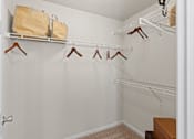 Thumbnail 15 of 40 - a walk in closet in a bedroom with a door open