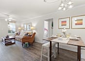 Thumbnail 8 of 40 - a living and dining room area with a wooden table and chairs and a couch in the background