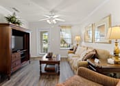 Thumbnail 9 of 40 - a living room with a couch and a coffee table