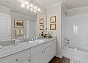 Thumbnail 17 of 40 - a bathroom with a sink and a bathtub