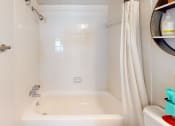 Thumbnail 10 of 19 - a bathroom with a shower and a sink and a shower curtain  at Somerset Apartments, Largo, Florida