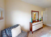 Thumbnail 7 of 19 - a bedroom with a bed and a dresser with a mirror  at Somerset Apartments, Florida, 33774