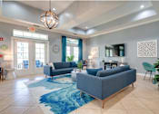 Thumbnail 14 of 26 - clubhouse shot with blue couches and rug at Magnolia Village Apartments, Jacksonville, 32207