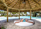 Thumbnail 30 of 35 - Poolside Relaxing Area at The Lotus at Village Walk, Fort Myers, FL