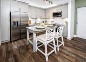 Thumbnail 3 of 35 - a kitchen with white cabinets and stainless steel appliances at The Lotus at Village Walk, Fort Myers, FL