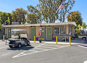 Thumbnail 9 of 11 - a building with a golf cart parked in front of it
