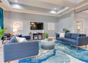 Thumbnail 16 of 26 - clubhouse with blue couches and a blue rug at Magnolia Village Apartments, Jacksonville, 32207