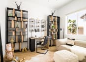 Thumbnail 6 of 33 - a living room with a couch and a desk in a home office at Onyx at Westgate Apartments, Glendale