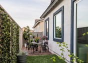 Thumbnail 18 of 33 - a patio with a table and chairs in a backyard at Onyx at Westgate Apartments, Glendale, Arizona