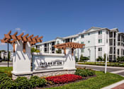 Thumbnail 45 of 51 - an exterior view of an apartment building with an entrance sign at Enclave at 3230 Apartments, Florida