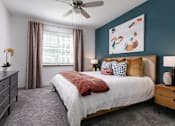 Thumbnail 12 of 51 - a bedroom with a bed and a ceiling fan at Enclave at 3230 Apartments, South Daytona, Florida