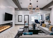 Thumbnail 32 of 51 - the living room has a fireplace and a large couch at Enclave at 3230 Apartments, Florida, 32119