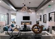 Thumbnail 33 of 51 - a living room with a fireplace and couches at Enclave at 3230 Apartments, Florida, 32119