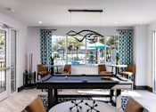 Thumbnail 36 of 51 - a pool table in the center of a living room at Enclave at 3230 Apartments, Florida