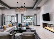 Thumbnail 30 of 51 - a living room with couches and a television and a fireplace at Enclave at 3230 Apartments, South Daytona, FL, 32119