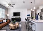 Thumbnail 10 of 51 - a living room and kitchen with a couch and a table at Enclave at 3230 Apartments, South Daytona, FL
