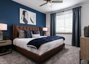 Thumbnail 11 of 51 - A bedroom with a large bed and a ceiling fan at Enclave at 3230 Apartments, South Daytona, Florida