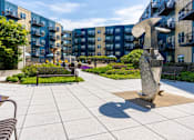 Thumbnail 24 of 26 - a sculpture of a dolphin in front of an apartment building at Wheaton 121, Illinois, 60187