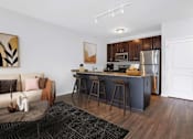 Thumbnail 1 of 26 - a kitchen with a bar and a living room with a couch at Wheaton 121, Illinois