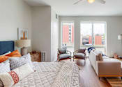 Thumbnail 25 of 54 - A bedroom with a large bed and a couch. at The Arlow on Kellog, St. Paul, MN, 55102