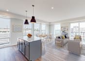 Thumbnail 3 of 54 - A modern kitchen with a dining table and chairs. at The Arlow on Kellog, St. Paul, MN