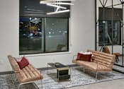 Thumbnail 31 of 54 - A modern living room with a large window and a view of the city at night. at The Arlow on Kellog, Minnesota
