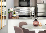 Thumbnail 1 of 19 - A kitchen with a table and chairs.