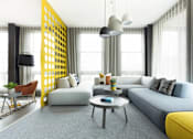 Thumbnail 13 of 19 - A modern living room with a grey sofa, a yellow accent, and a yellow and black geometric wall panel.