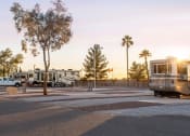 Thumbnail 22 of 26 - a campsite with trucks and rvs parked in the parking lot