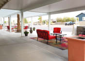 Thumbnail 8 of 26 - a patio with red chairs and a fire place