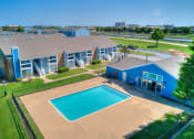 Thumbnail 12 of 24 - an aerial view of a building with a swimming pool