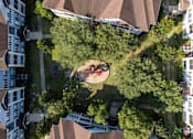 Thumbnail 21 of 26 - a birdseye view of a park with people sitting on the grass at Magnolia Village Apartments, Jacksonville, FL, 32207