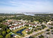Thumbnail 23 of 26 - an aerial view of a neighborhood with a lake and a city in the background at Magnolia Village Apartments, Jacksonville, 32207