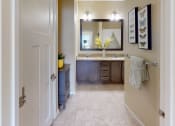 Thumbnail 13 of 49 - a bathroom with a sink and a mirror at Skye at Arbor Lakes, Minnesota