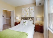 Thumbnail 11 of 49 - a bedroom with a bed and two night stands with lamps at Skye at Arbor Lakes, Maple Grove, MN