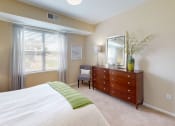 Thumbnail 10 of 49 - a bedroom with a large window and a dresser with a mirror at Skye at Arbor Lakes, Maple Grove, 55369