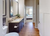 Thumbnail 25 of 49 - a bathroom with a toilet sink and mirror at Skye at Arbor Lakes, Maple Grove, 55369