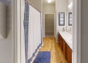 Thumbnail 15 of 44 - a bathroom with a white and blue shower curtain