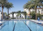Thumbnail 38 of 40 - a large swimming pool with a pergola and palm trees in the background at Odyssey, Fort Myers, Florida