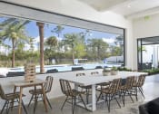 Thumbnail 34 of 40 - a large white table and chairs sit in front of a large window with a view of a at Odyssey, Fort Myers, FL, 33905