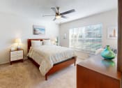 Thumbnail 6 of 19 - a bedroom with a bed and a ceiling fan  at Somerset Apartments, Largo, Florida