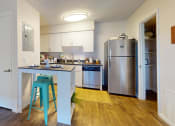 Thumbnail 3 of 19 - a kitchen with a blue counter top and a stainless steel refrigerator  at Somerset Apartments, Largo, Florida