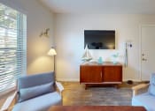 Thumbnail 5 of 19 - a living room with two blue couches and a television  at Somerset Apartments, Largo, 33774